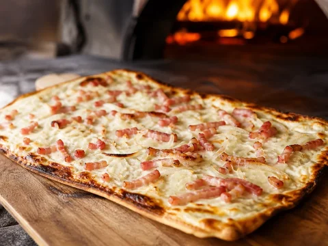 Tarte flambée alsacienne authentique (flammekueche) : pâte fine, crème, oignons et lardons